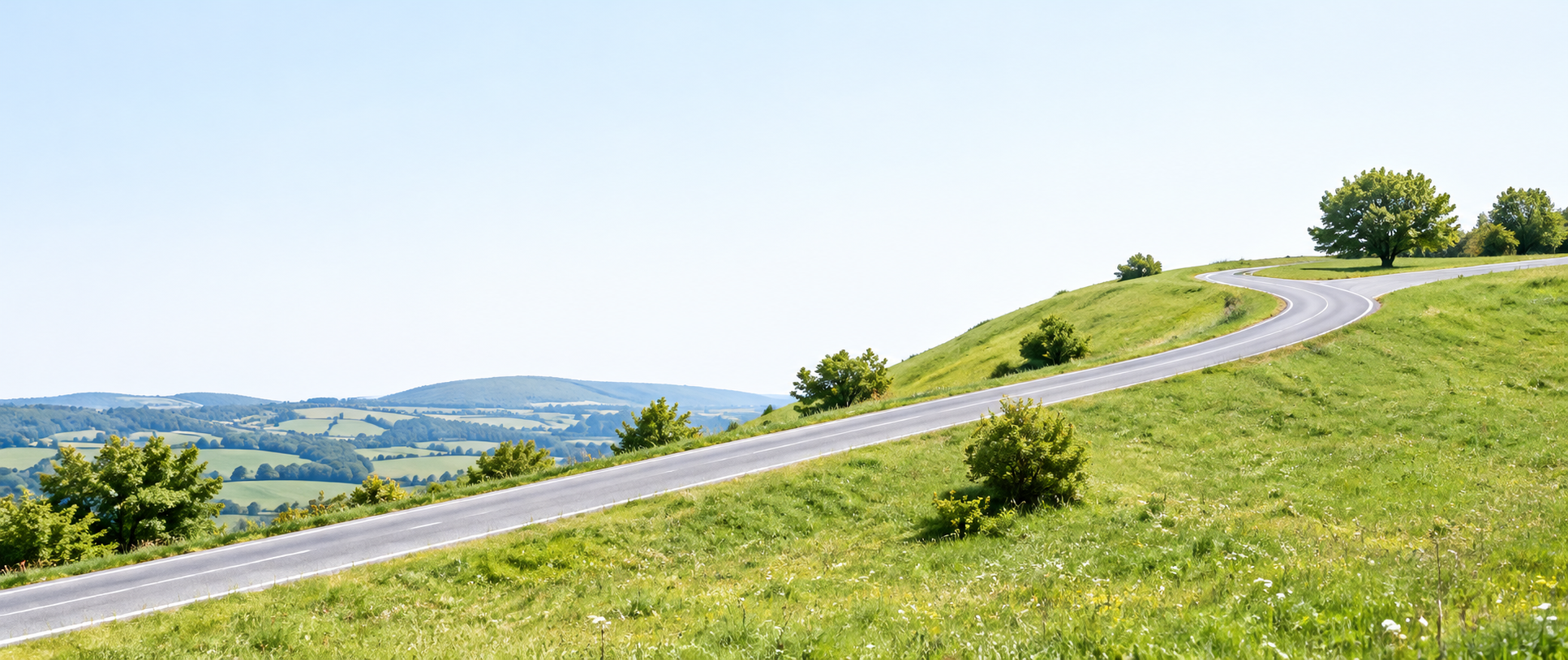 Illustrative green hillside with an uphill country road